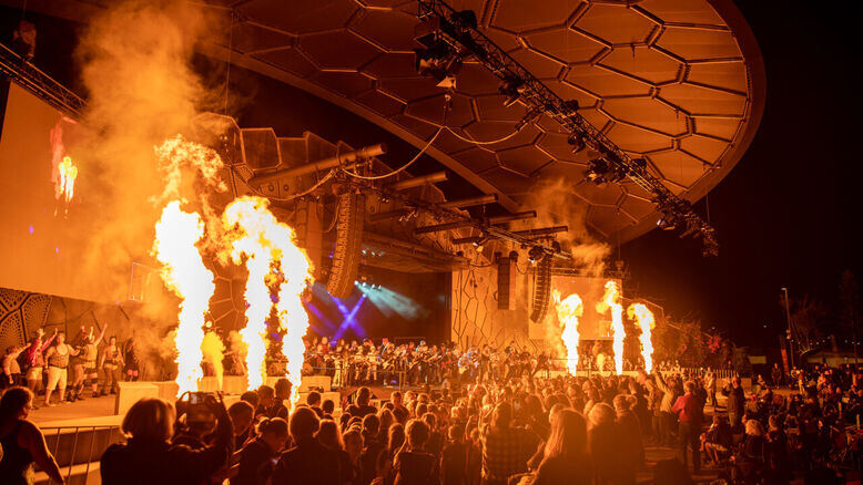 Crowds enjoying a fire-lit live performance at HOTA Outdoor Stage, a hub for Gold Coast entertainment featuring concerts, festivals, and cultural events.