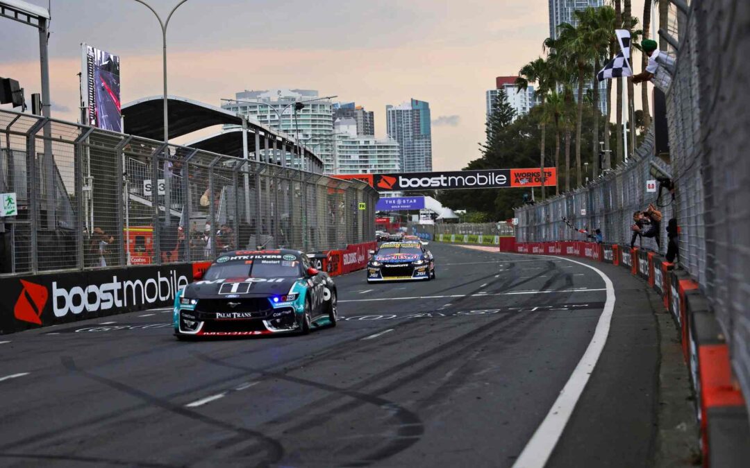 what's on gold coast at the Boost Mobile Gold Coast 500, Supercars racing on the Surfers Paradise street circuit as a chequered flag waves near the finish line